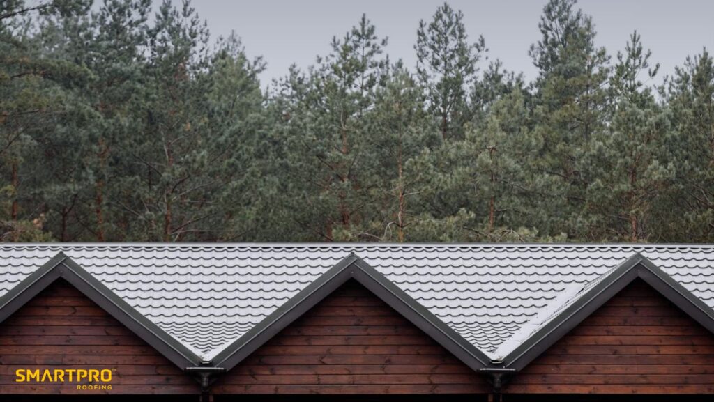 A snowy rooftop with a contractor applying shingles