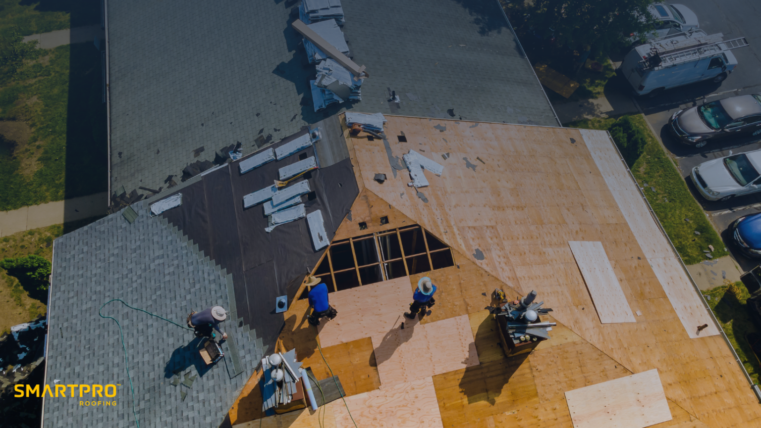 Aerial view of a roof replacement in progress with SmartPRO Roofing team at work.