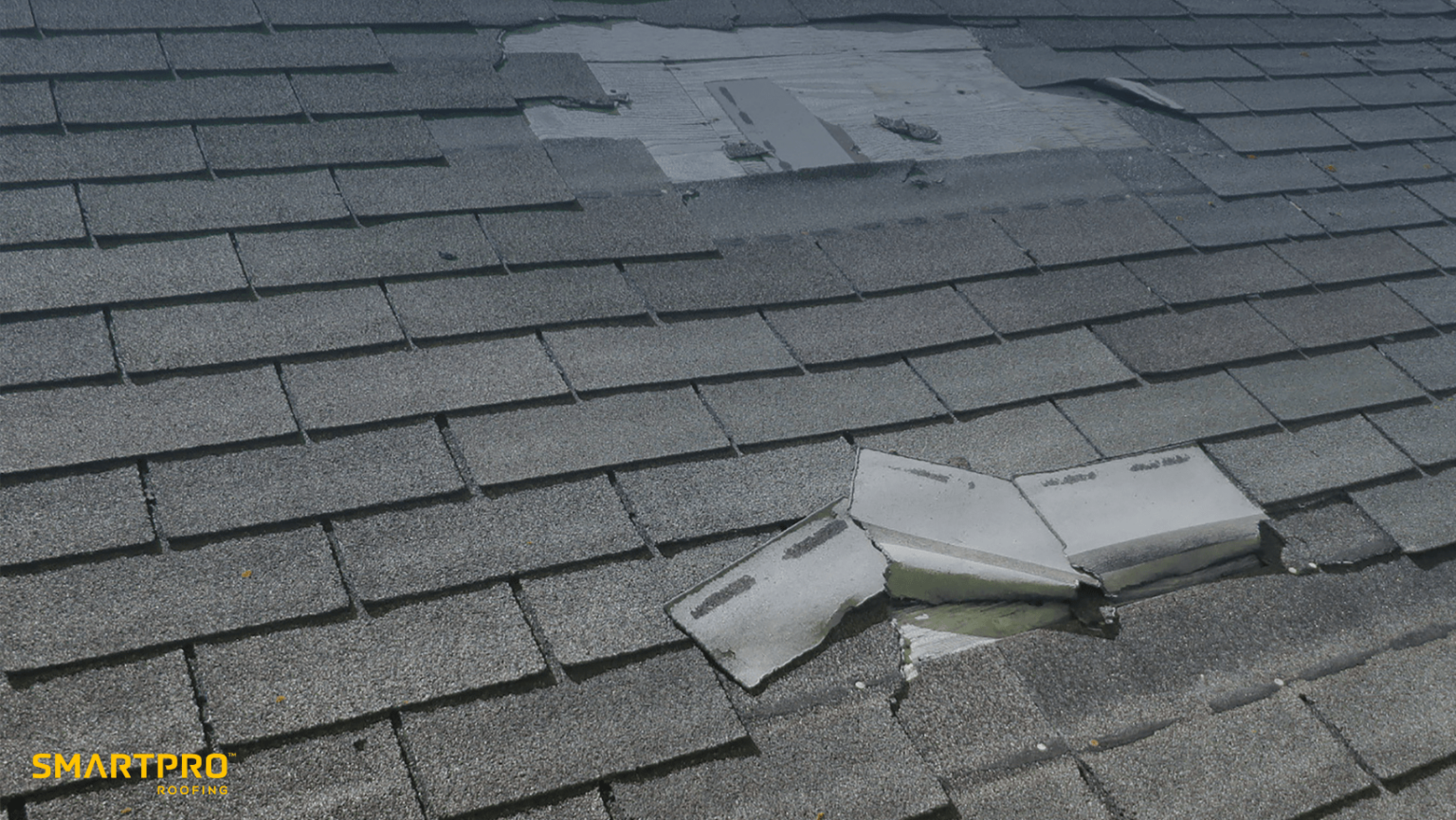 A damaged roof featuring a broken window, highlighting the importance of careful roof purchasing decisions.