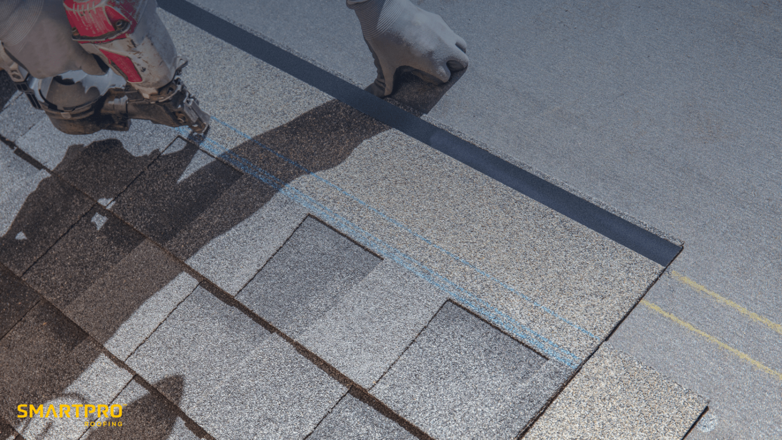 A person operates a nailer to securely install a shingle on a roof, demonstrating skilled craftsmanship in roofing.