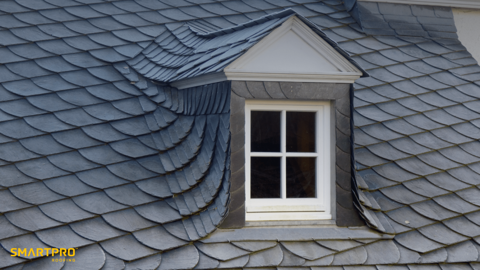 A rooftop window allowing natural light to illuminate the space below, framed by the surrounding roof structure.