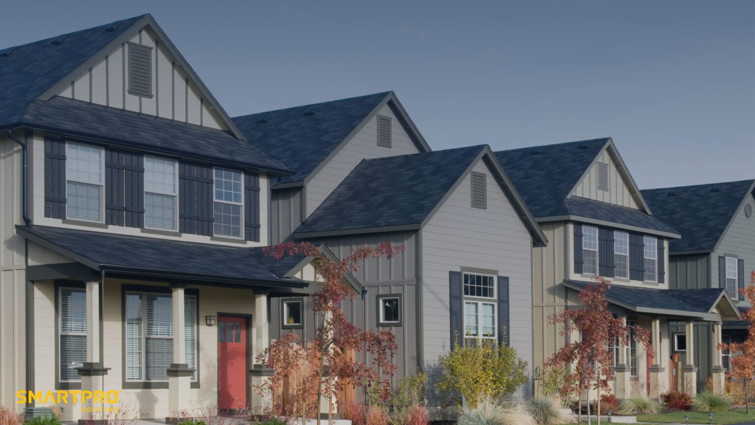 A row of houses featuring gray siding complemented by elegant black trim, showcasing a modern architectural style.