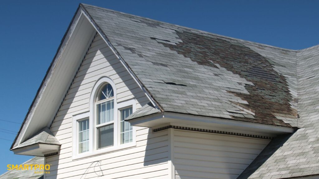 Should I Replace My Roof Even If It’s Not Leaking? A Smart Homeowner’s Guide to Proactive Roof Replacement 11 A roof with damaged shingles and a window