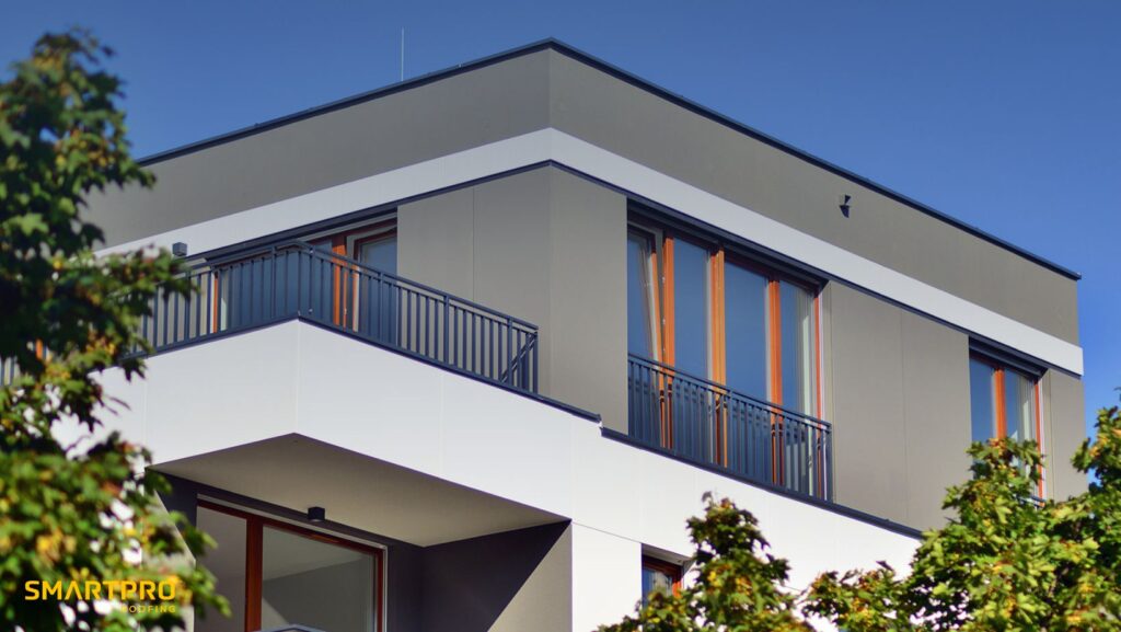 Do Flat Roofs Perform Better Than a Gable Roof? 7 A modern building featuring a prominent balcony