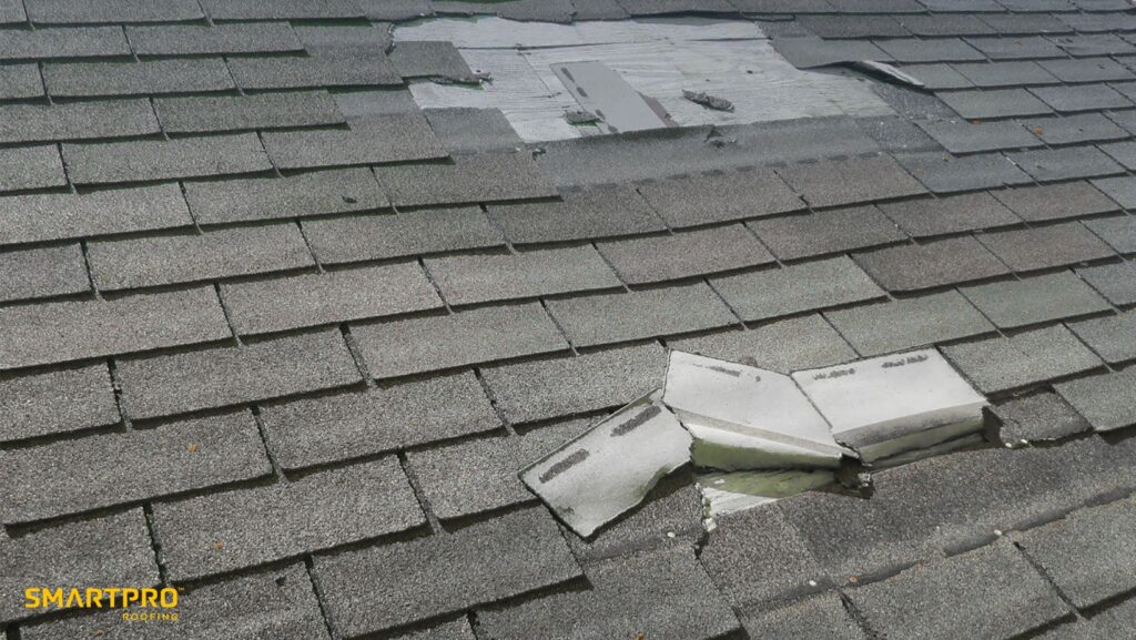 A roof showing visible damage with a broken shingle