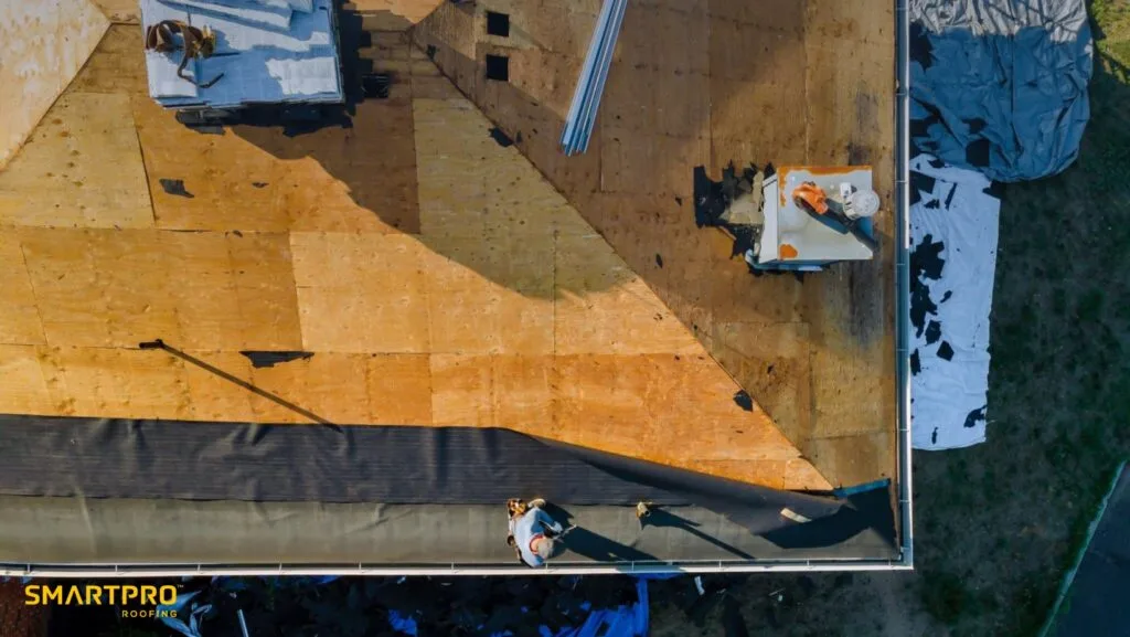 A man is climbing a ladder to work on a roof