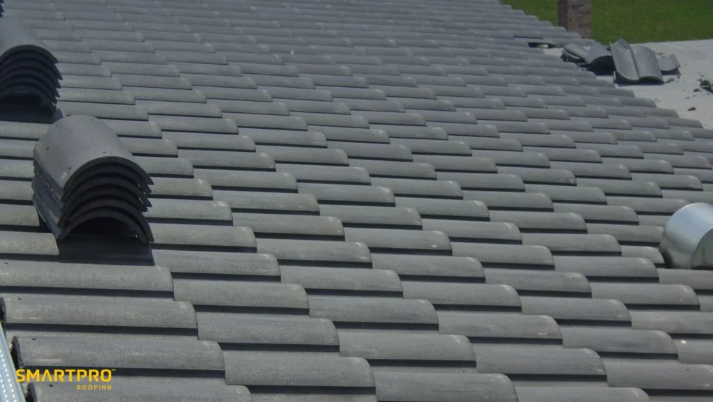 A gray tiled roof featuring a prominent yellow roof vent.