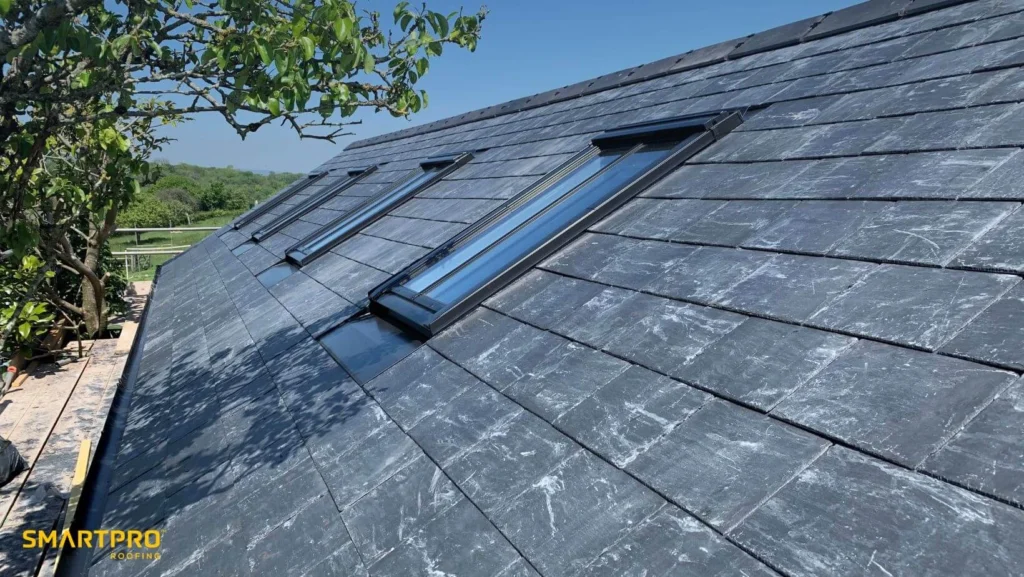 A roof covered with black slate shingles, showcasing a sleek and modern architectural design.