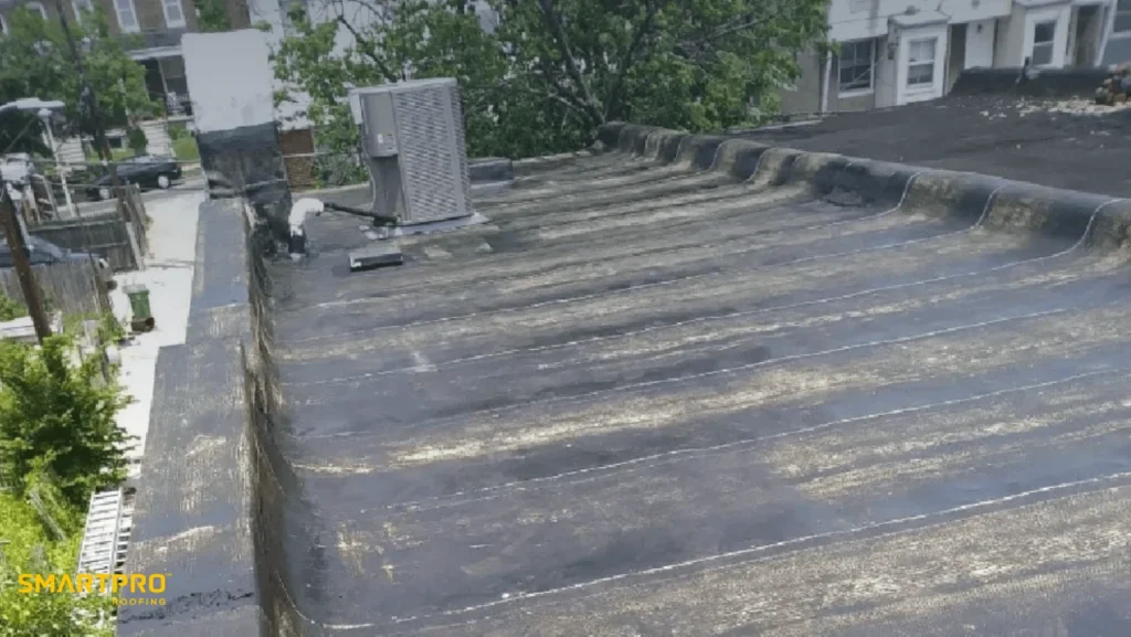 A close-up view of a roof featuring a sleek, modern metal roofing system in a residential setting