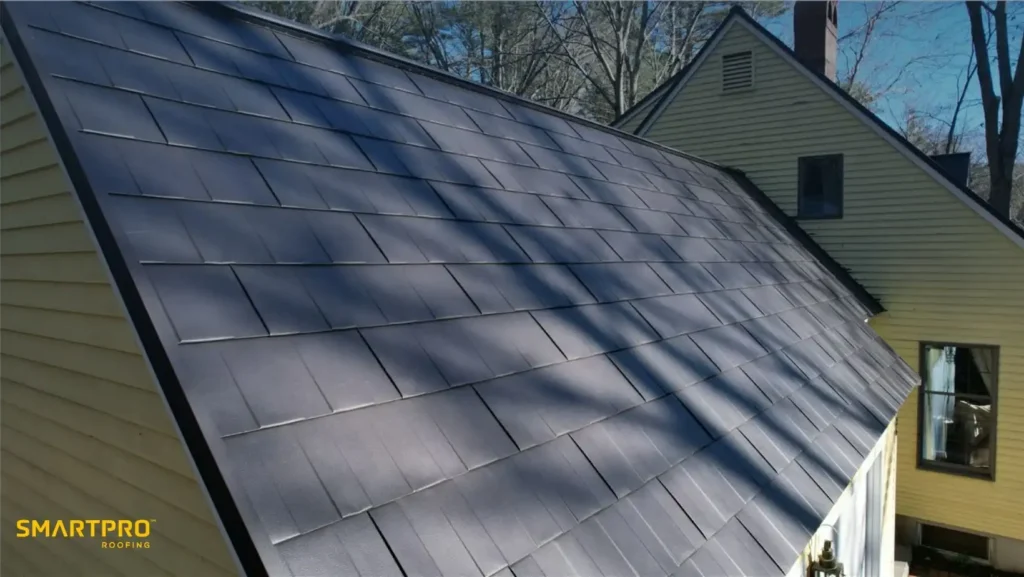 Steel Shingles: Durable, Stylish, and Long-Lasting Roofing Solutions 12 A house with a modern black shingle roof, sloping steeply, under clear skies. The siding is light yellow. Calm, sophisticated atmosphere.