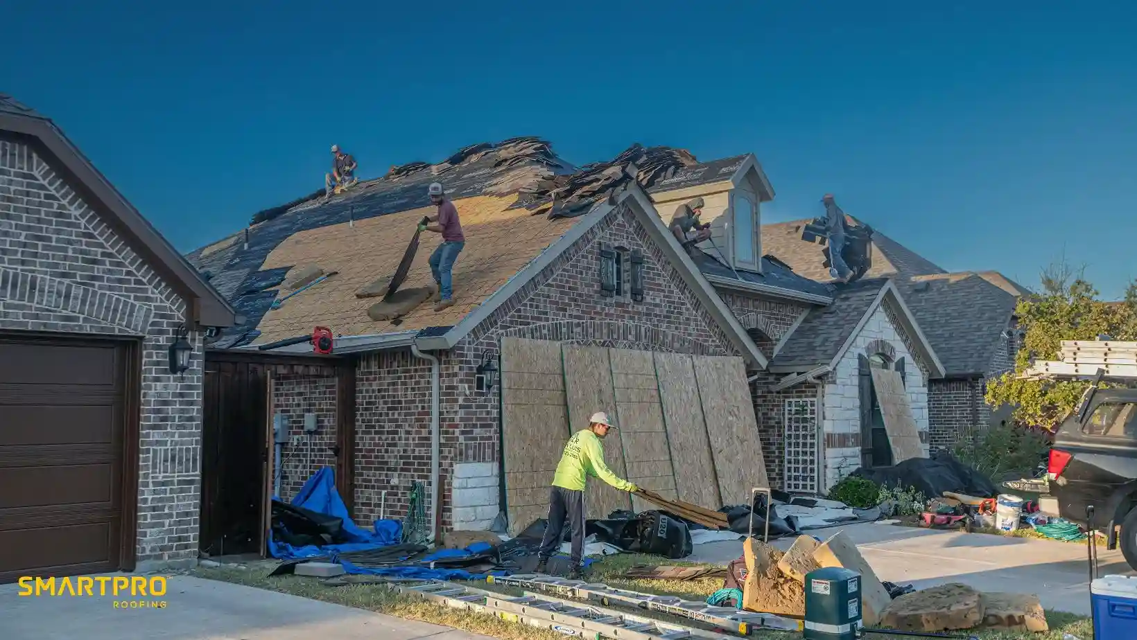 SmartQuote Explained: What Satellite Technology Sees That a Ladder Can't 11 Professional roofing contractors replacing shingles on a residential home during a full roof replacement project.
